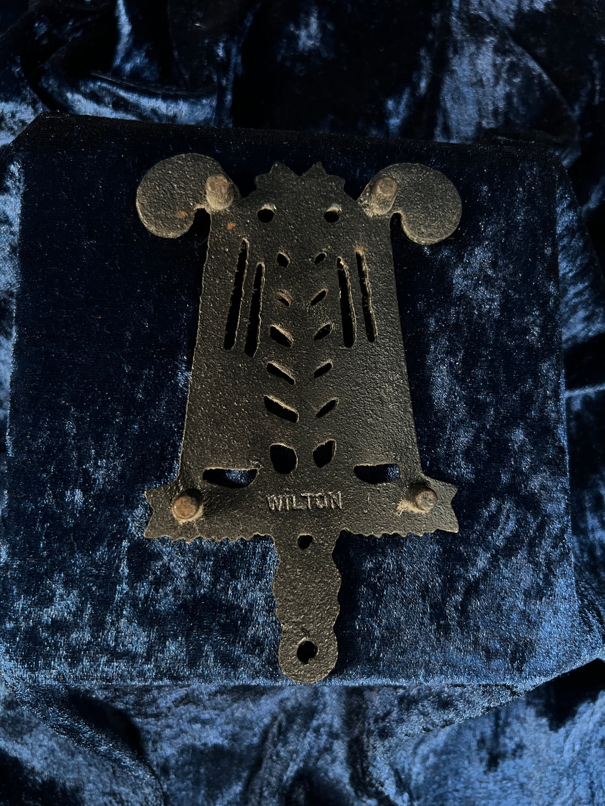 Vintage Iron Wilton Trivet - Brooms, Foliage, and Heart Motif