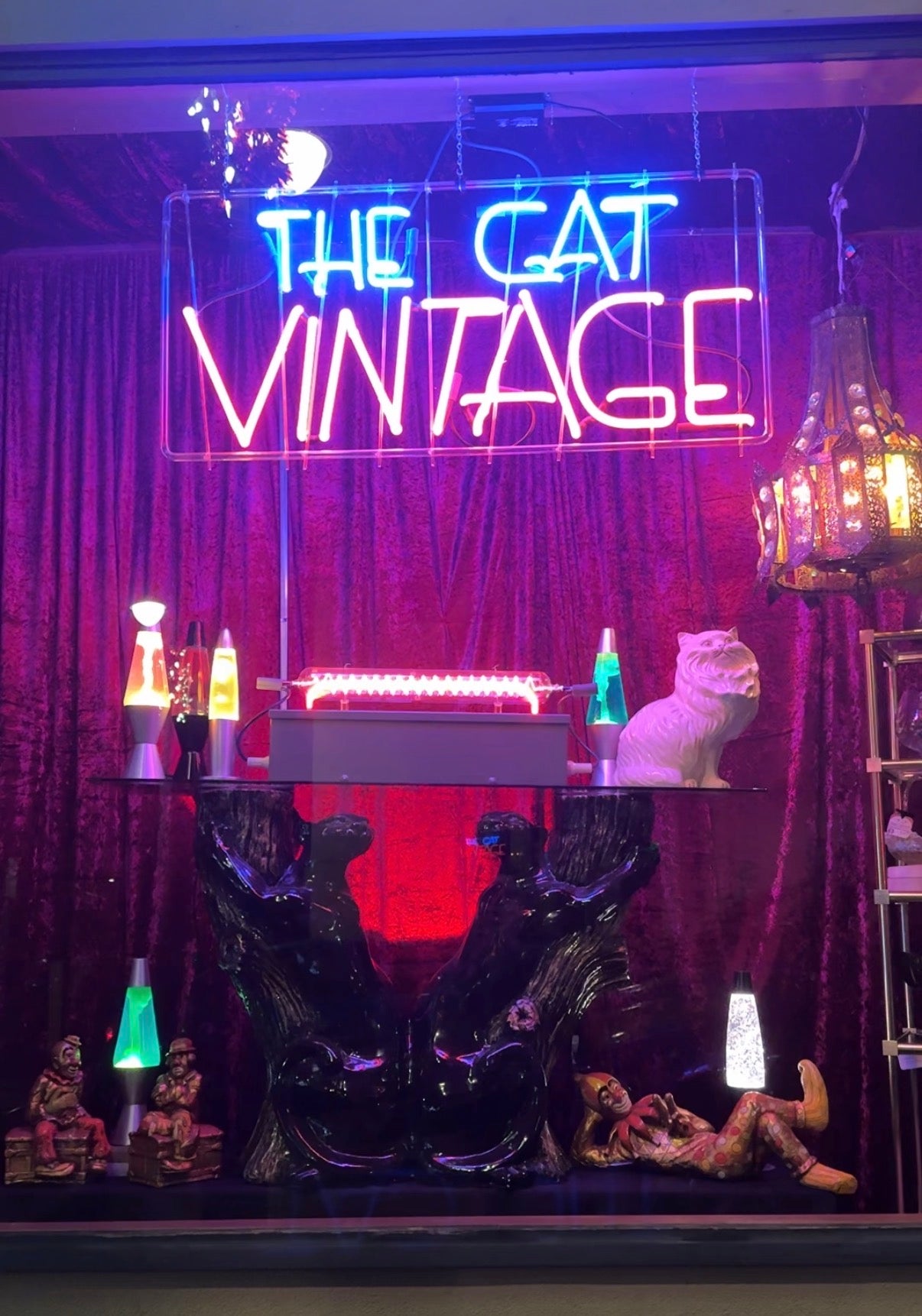 The Cat Vintage & Antiques storefront window display in Crockett